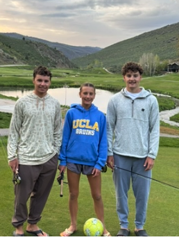 Three siblings standing together outdoors in Park City